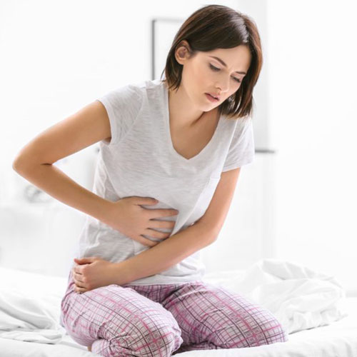 Woman experiencing abdominal discomfort – Ayurvedic gynecology treatment in Dubai
